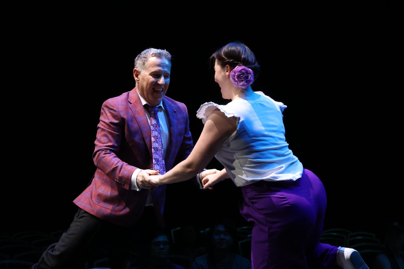 Leigh & Scott - two of our senior teachers dancing in a spotlight.